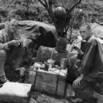 U.S. 77th Infantry Division Chaplain and soldier eat K-Rations on Guam
