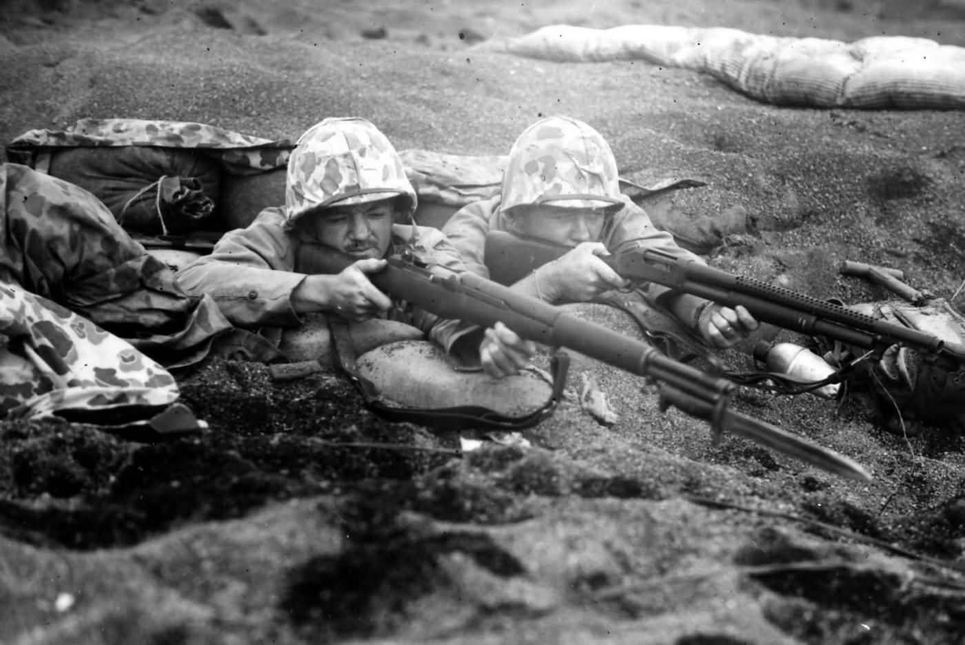 A pair of Marines in a dug out position await a Japanese counter attack