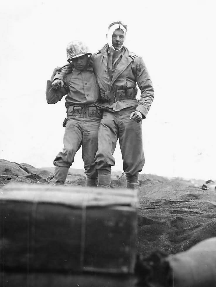 Marine of 5th Division helps wounded comrade on Iwo Jima