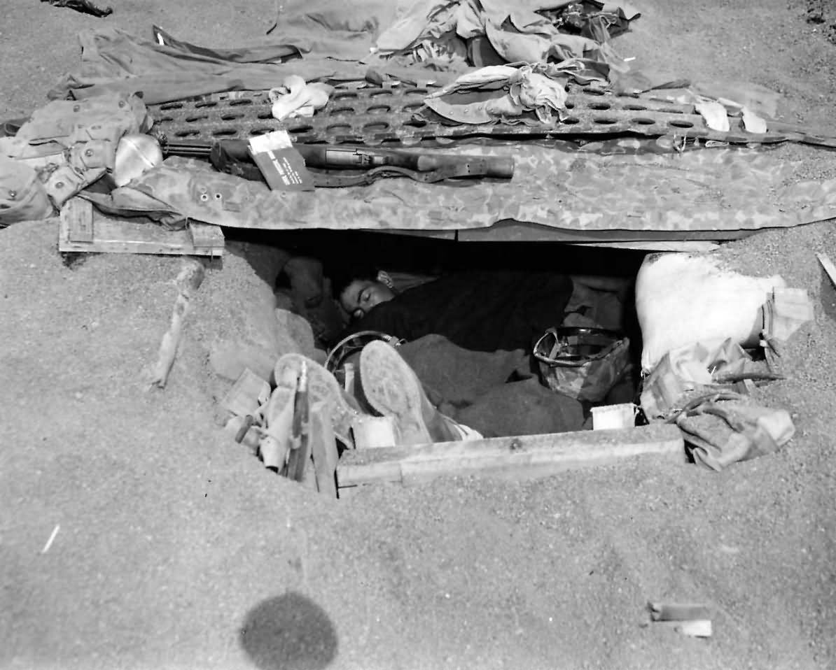 Marine sleeping in foxhole on Iwo Jima