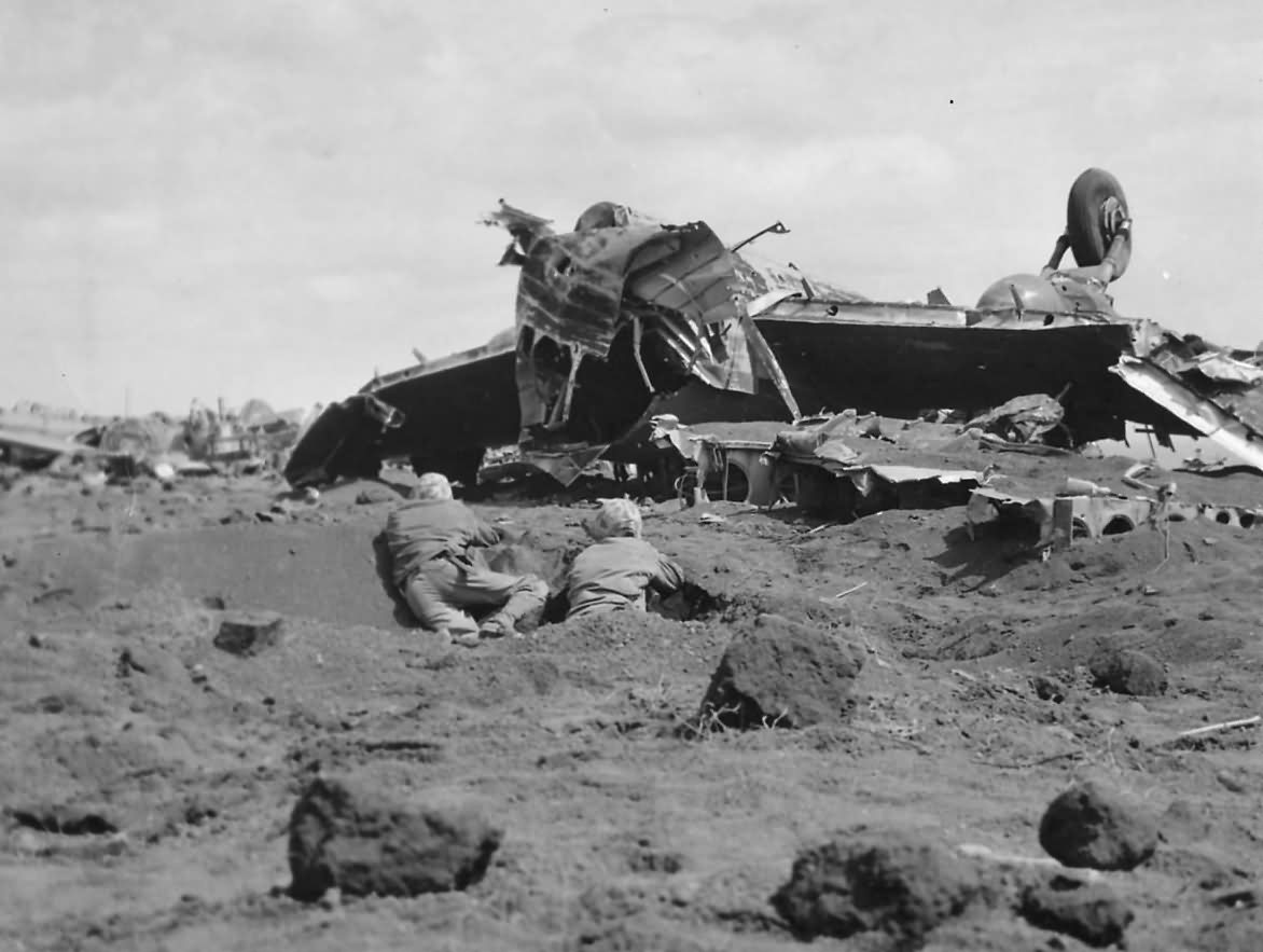 Marines Use Japanese Plane For Cover on Motoyama Airfield Iwo Jima