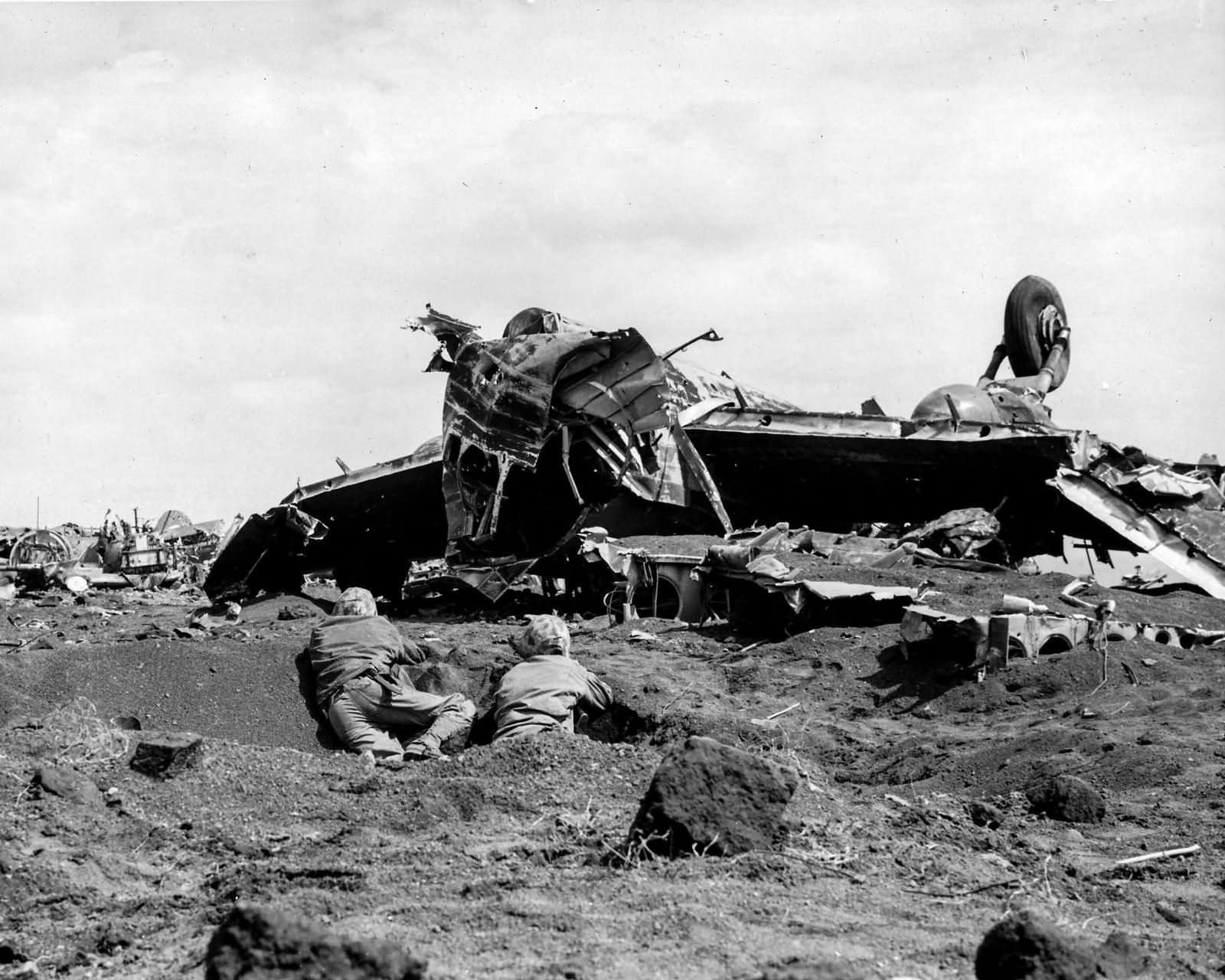 Wrecked Japanese aircraft and Marines on Motoyama airfield Iwo Jima