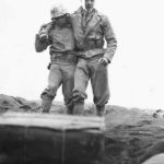 Marine of 5th Division helps wounded comrade on Iwo Jima