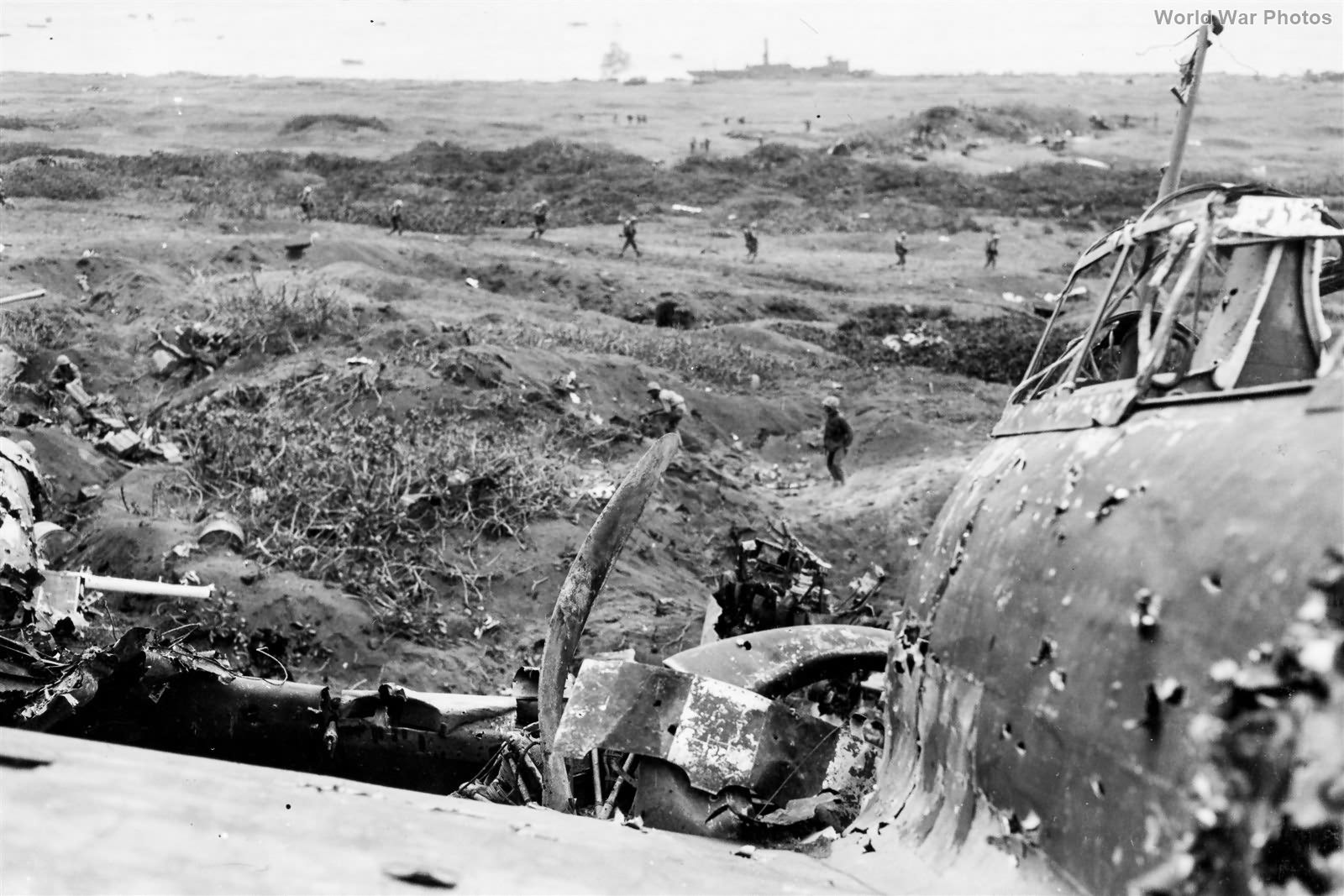 23rd Marines clear pillbox by wrecked A6M5