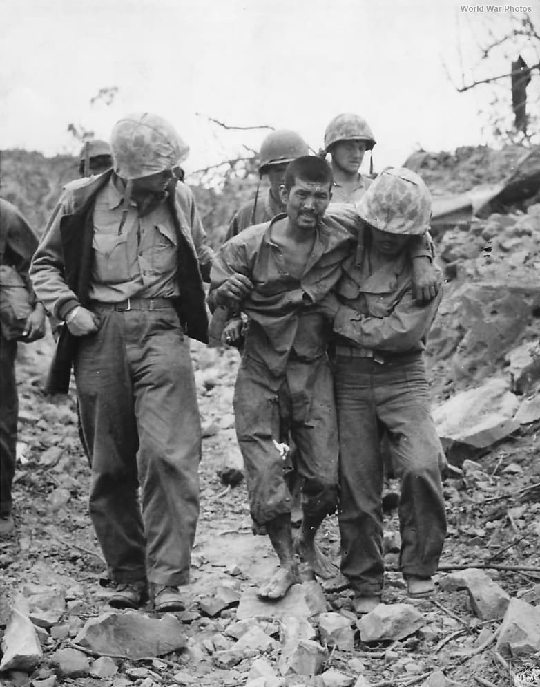 Marines help wounded Japanese Prisoner on Iwo Jima