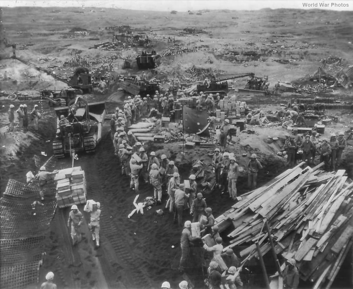 Marines use dozers to land supplies on the beach of Iwo Jima