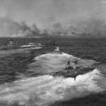 LVTs Head for Invasion Shore as Battleship blasts Iwo Jima