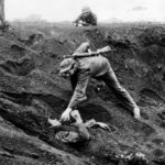 Marine approaches a Japanese soldier on Iwo Jima
