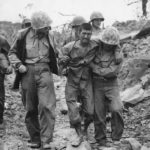 Marines help wounded Japanese Prisoner on Iwo Jima