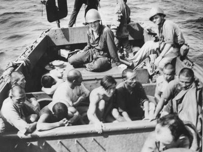 U.S .Coast Guardsmen with captured Japanese at Kwajalein 1944