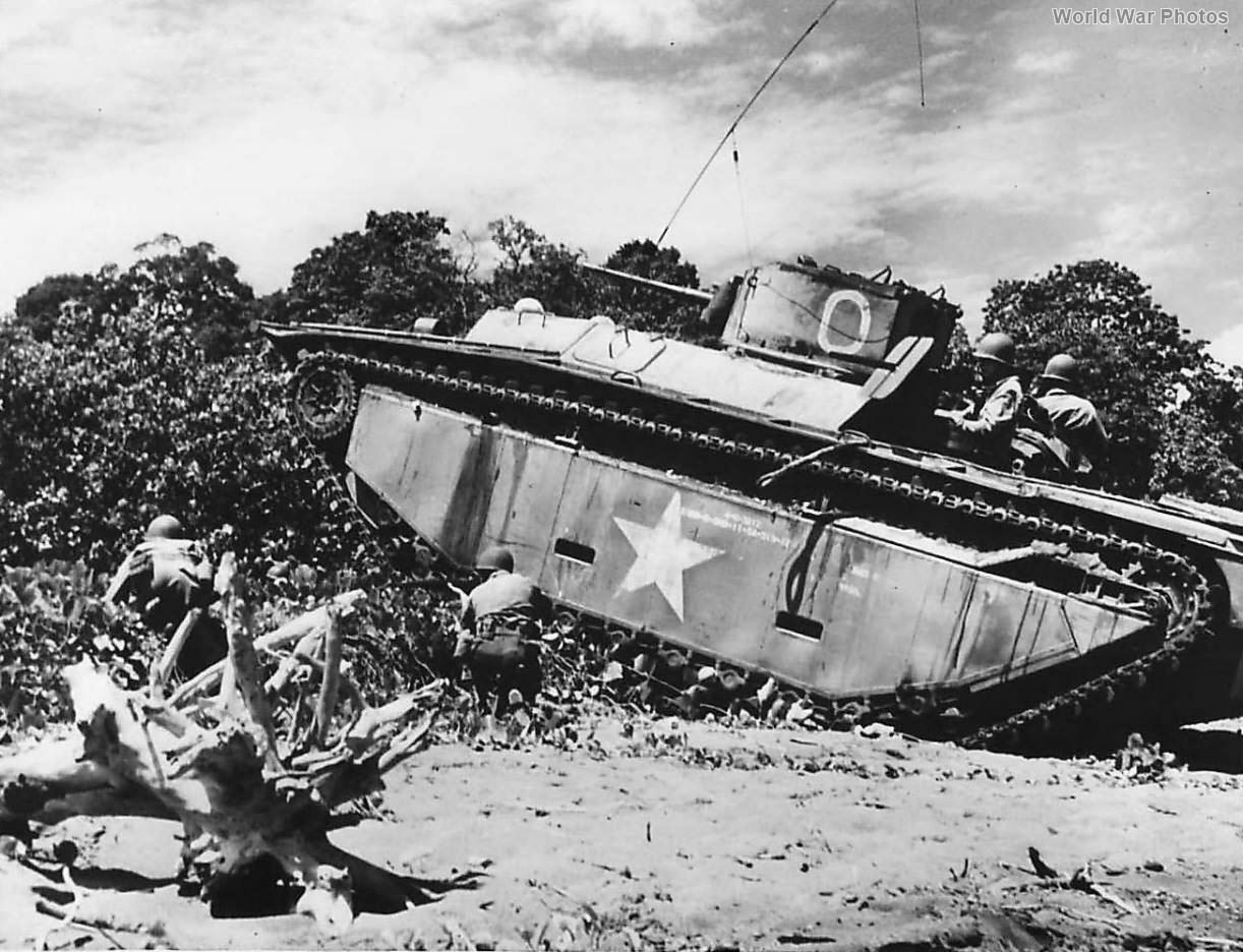 Infantrymen advance under the cover of an LVT