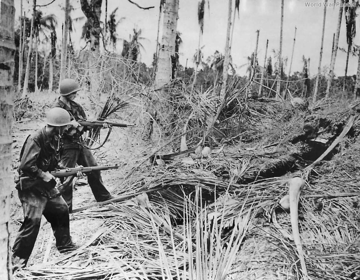 Troops of 32nd Division fire into Japanese dugout at Buna 1943