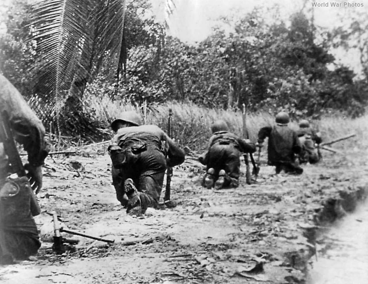 US troops crawl thru clearing under sniper fire on New Guinea 1943
