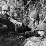 GI with Thompson submachine gun in fox hole Buna 22 February 1943