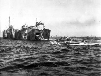 USS LSM-322 in the far background off Okinawa Beachhead on April 1st as a Coast Guard manned LST in the foreground launches a LVT-4 amphibious tractor