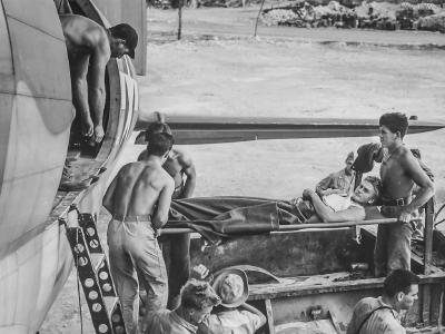 1st Marine Division loading a wounded man aboard a C-46 October44