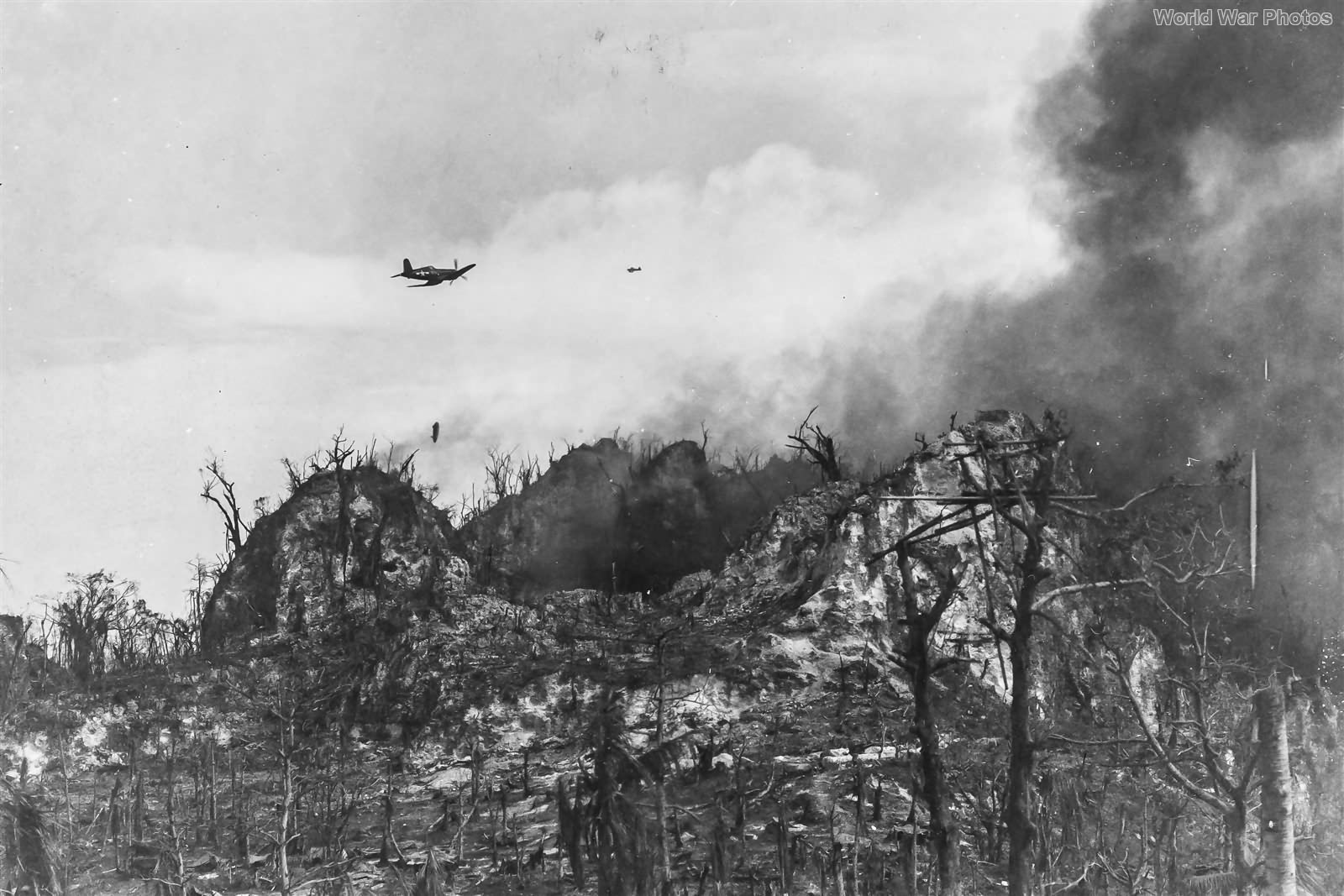 Marine F4U making a napalm run against Japanese defenses 3