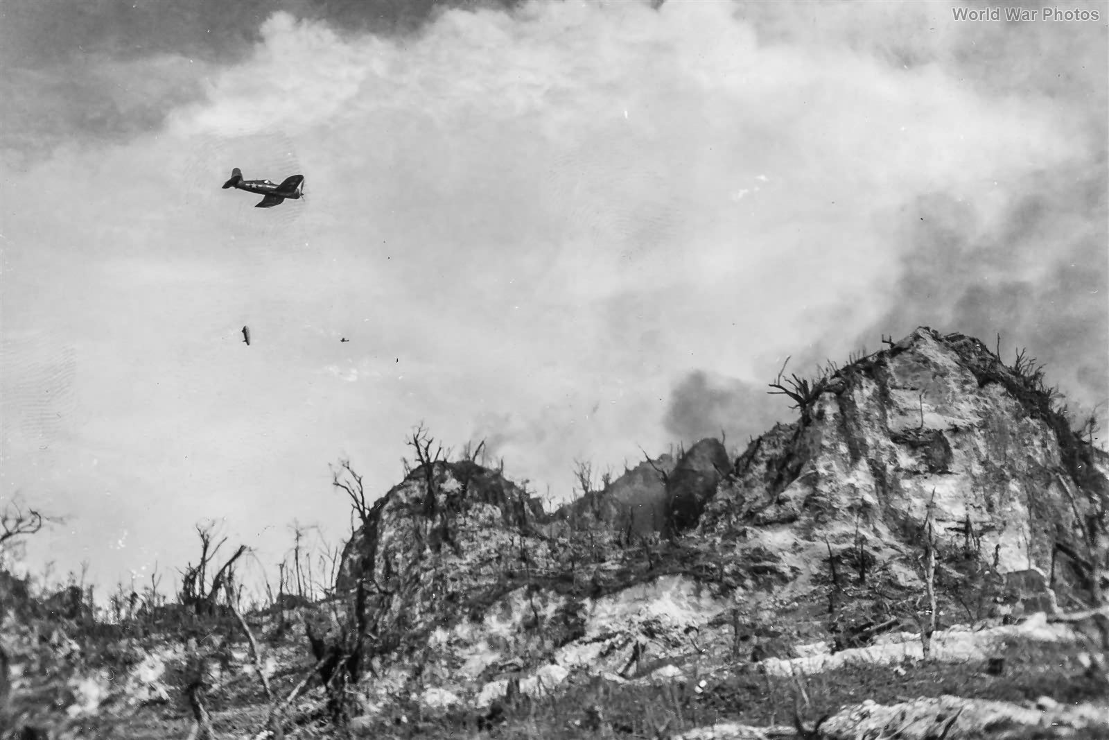 Marine F4U making a napalm run against Japanese defenses 4