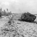 DUKW smoldering on the beach at Peleliu after taking a hit from indirect fire