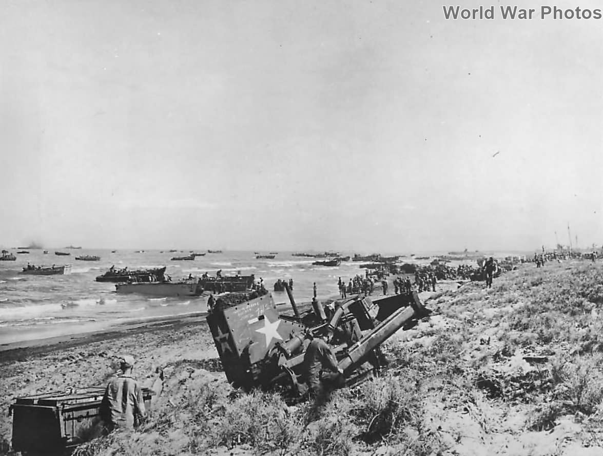 Armored bulldozer at work as troops land on Luzon Beach Lingayen ’45
