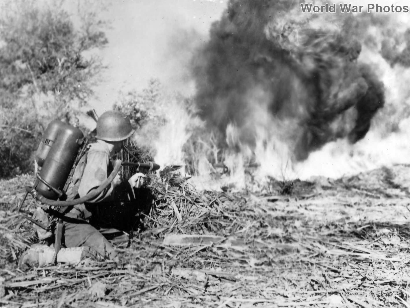 GI blasting Japanese position with flame thrower at Nanacag January 1945