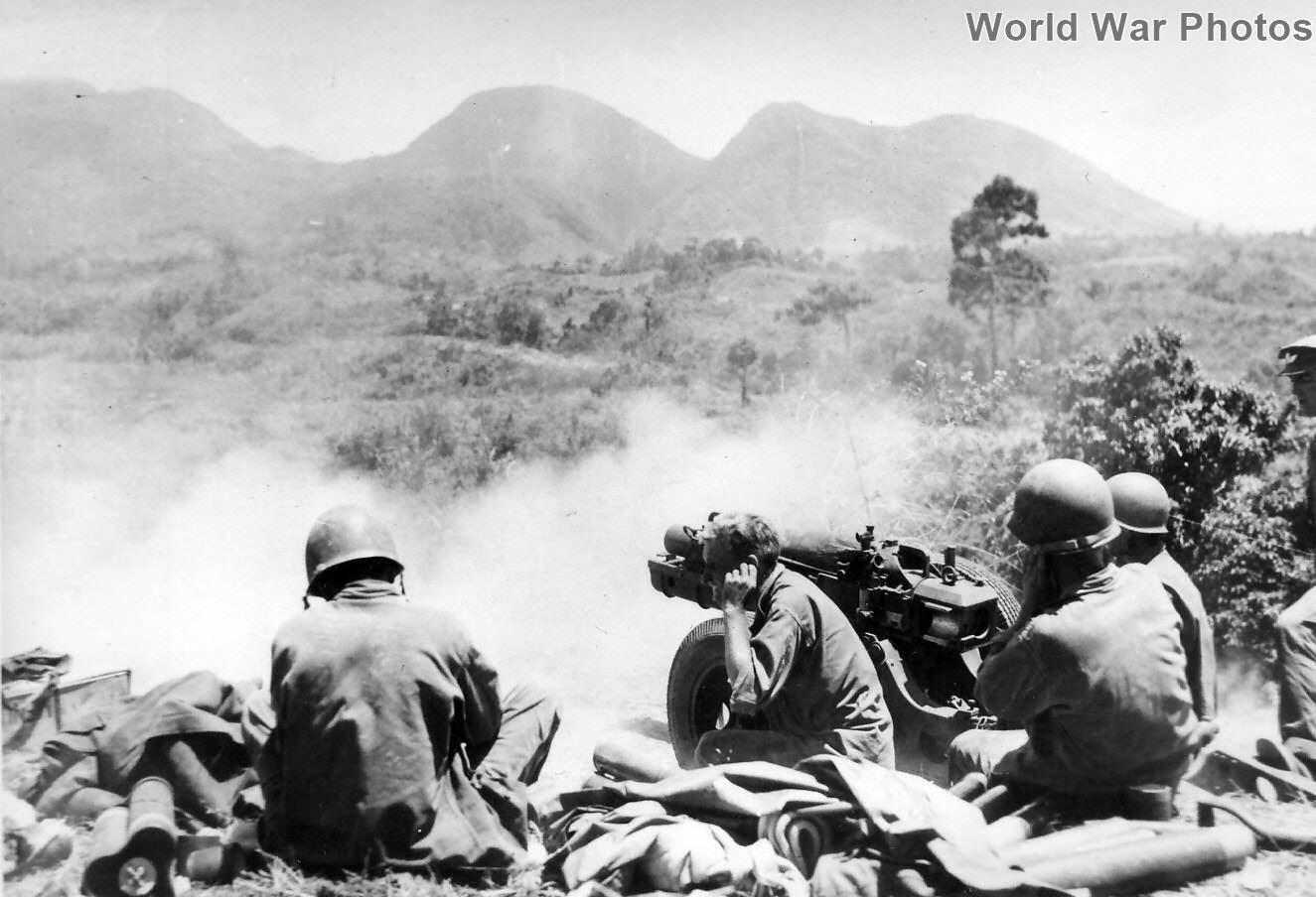 GIs fire 75mm Pack Howitzer M1 at Japanese, Negros