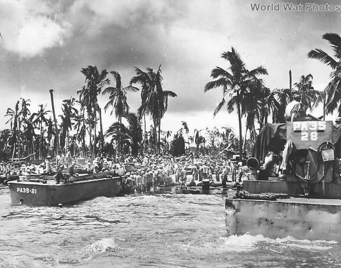 Landing Craft from USS Callaway unload troops supplies on Leyte