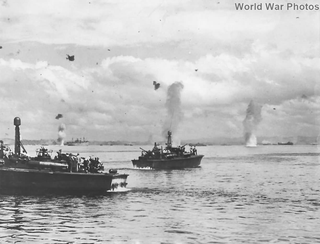 PT Boats stand by as Japanese bombs explode in Leyte Gulf