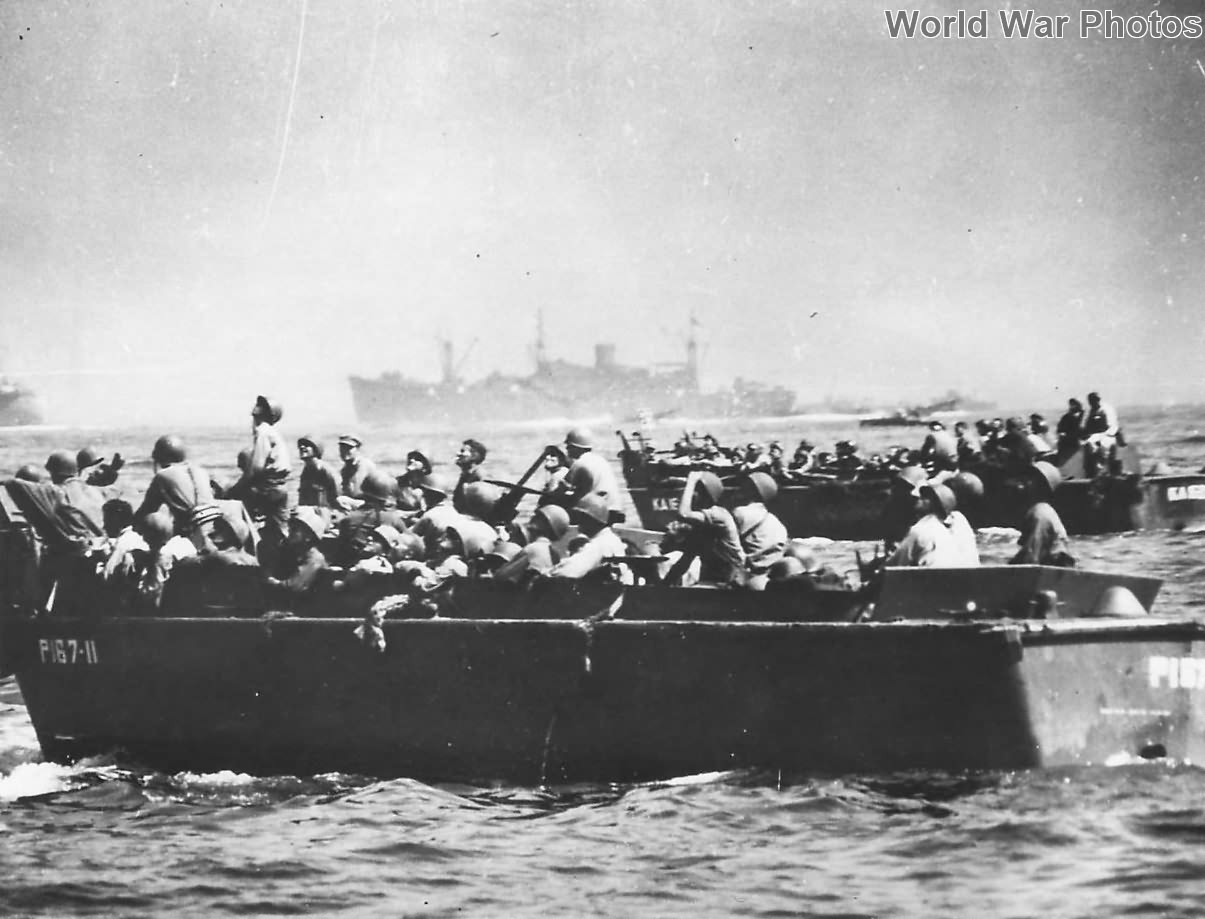 Troops in headed for Leyte invasion beach watch battle overhead