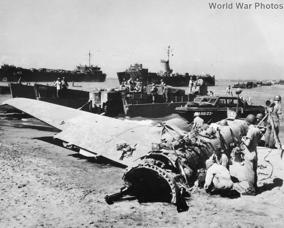 US Forces land by wrecked Japanese plane on Luzon Beach
