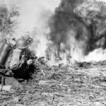 GI blasting Japanese position with flame thrower at Nanacag January 1945