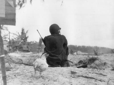 Coast guardsman with M1 carbine guards beach Saipan 1944