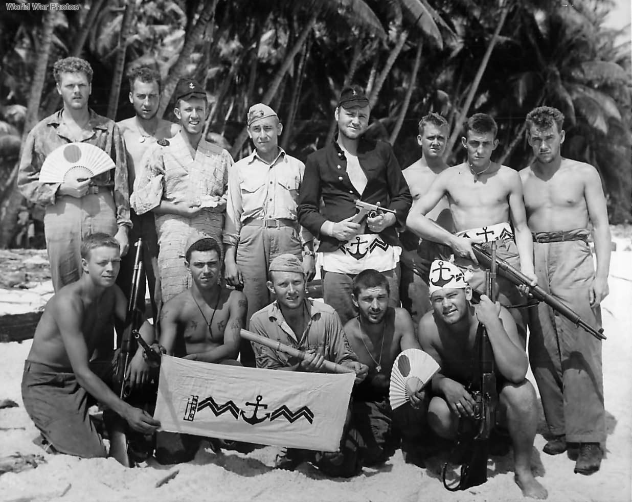 Marines on Tarawa display various Japanese battle trophies