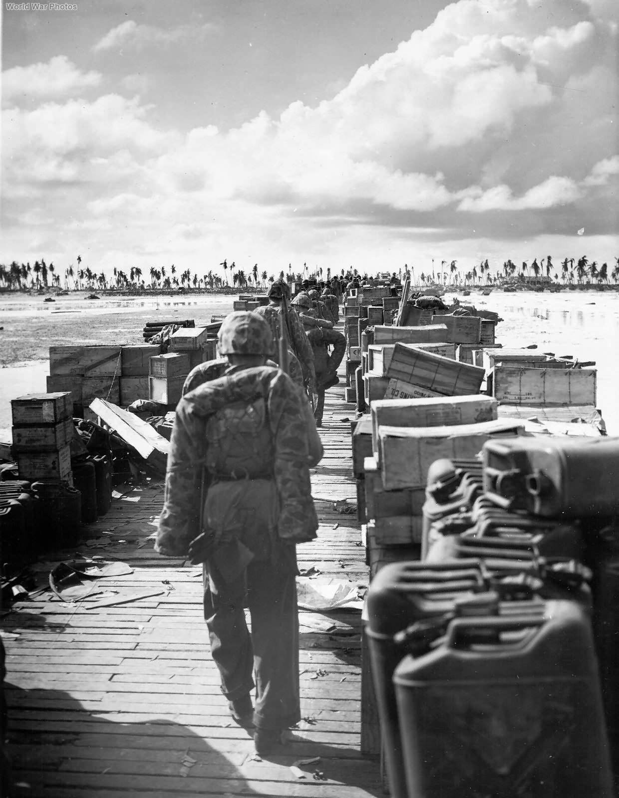 USMC reinforcements march down pier