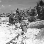 Marines on Red Beach 3 advancing to burns Phillips Pier Tarawa