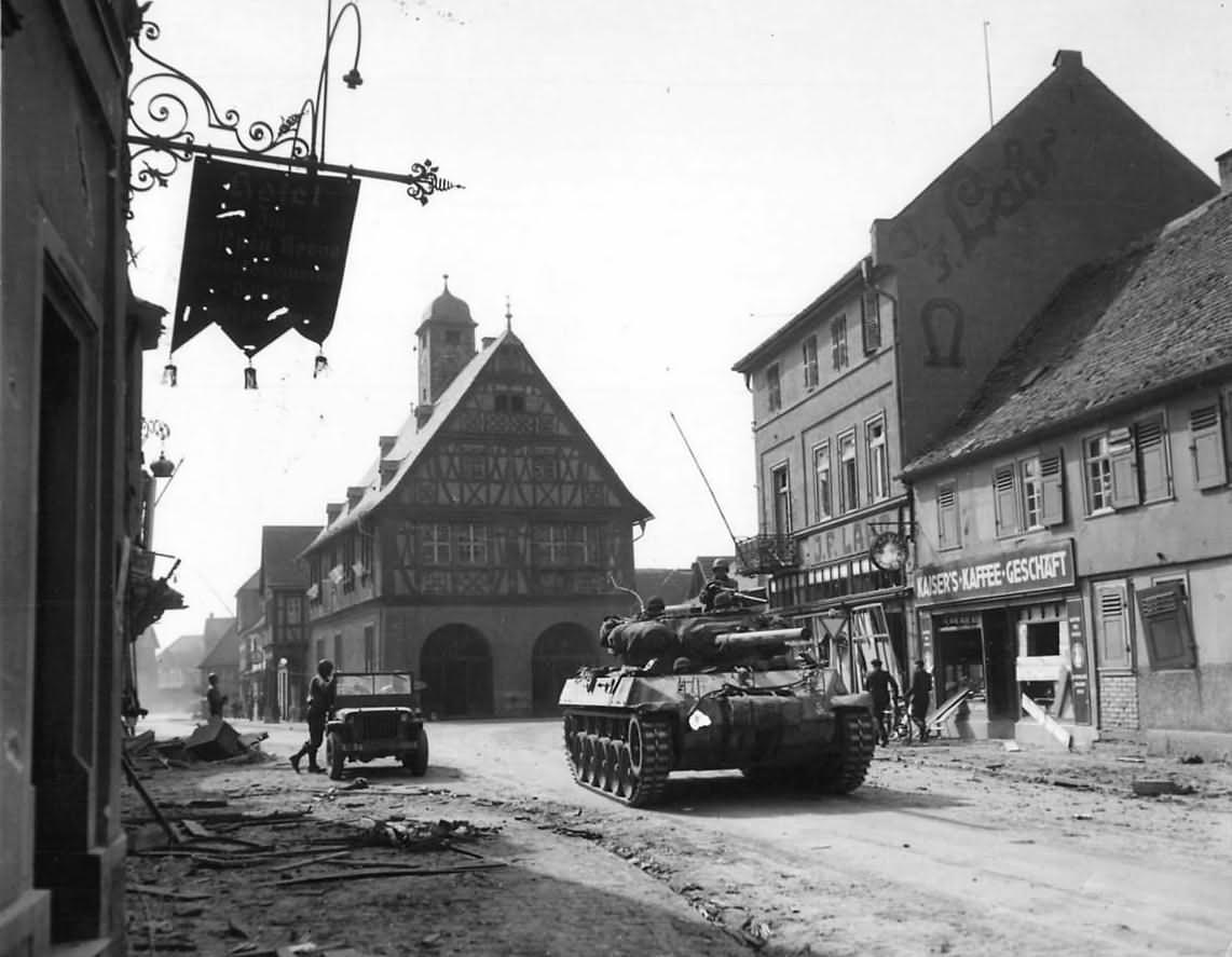M18 Hellcat and troops of the 3rd Army move thru Gros Gerau, Germany, 1945