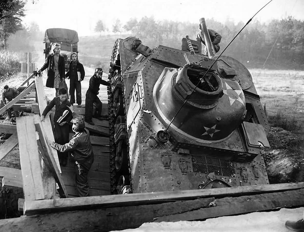 2nd Armored Division Troops Help Children Past Crashed M3 lee