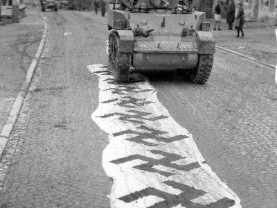 11th Armored Division M5 Stuart Runs Over Captured German Flags Lembach 1945