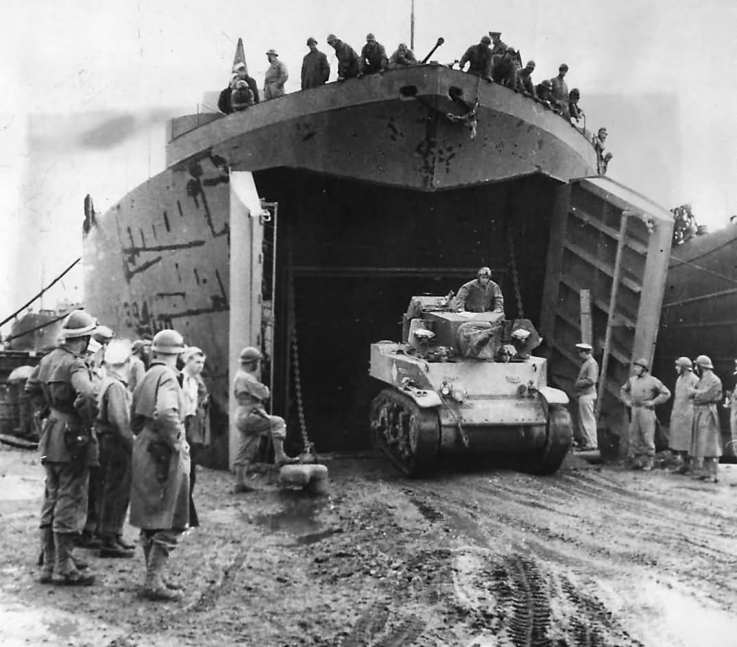 French Troops Watch M5 Stuart Tank Back Into LST-394 In North Africa 1943