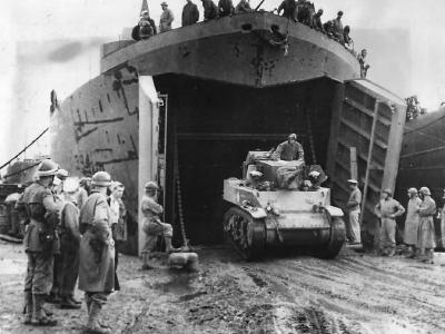 French Troops Watch M5 Stuart Tank Back Into LST-394 In North Africa 1943