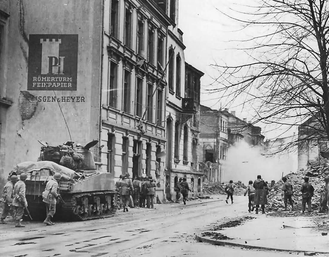 3rd Army soldiers advance with M4 Sherman tank toward Cathedral in Cologne Germany 1945