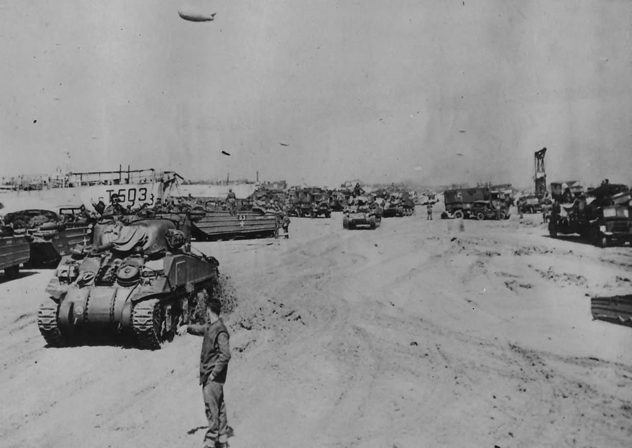 British Sherman tanks and DUKWs on Normandy Beach 7 June 1944