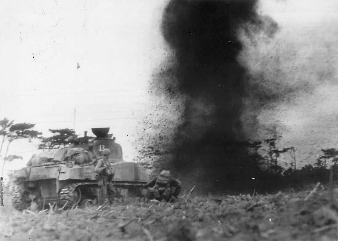 M4 Sherman Tanks and troops of the 10th Army advance through a mine field on Okinawa