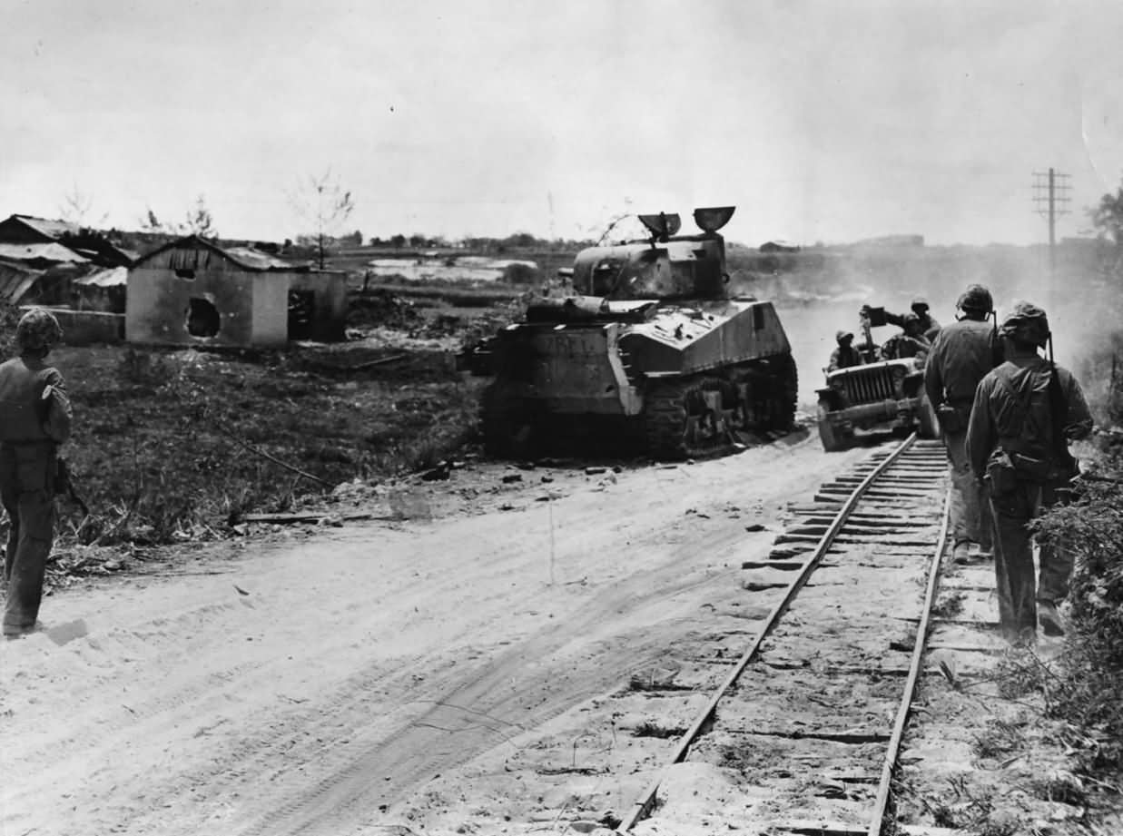 Marines Advance Past Knocked Out M4 Sherman Tank on Saipan 1944