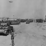 British Sherman tanks and DUKWs on Normandy Beach 7 June 1944