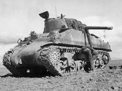 Crewman Adjusts Boggie Wheel on M4 Sherman Tank in Tunisia 1943