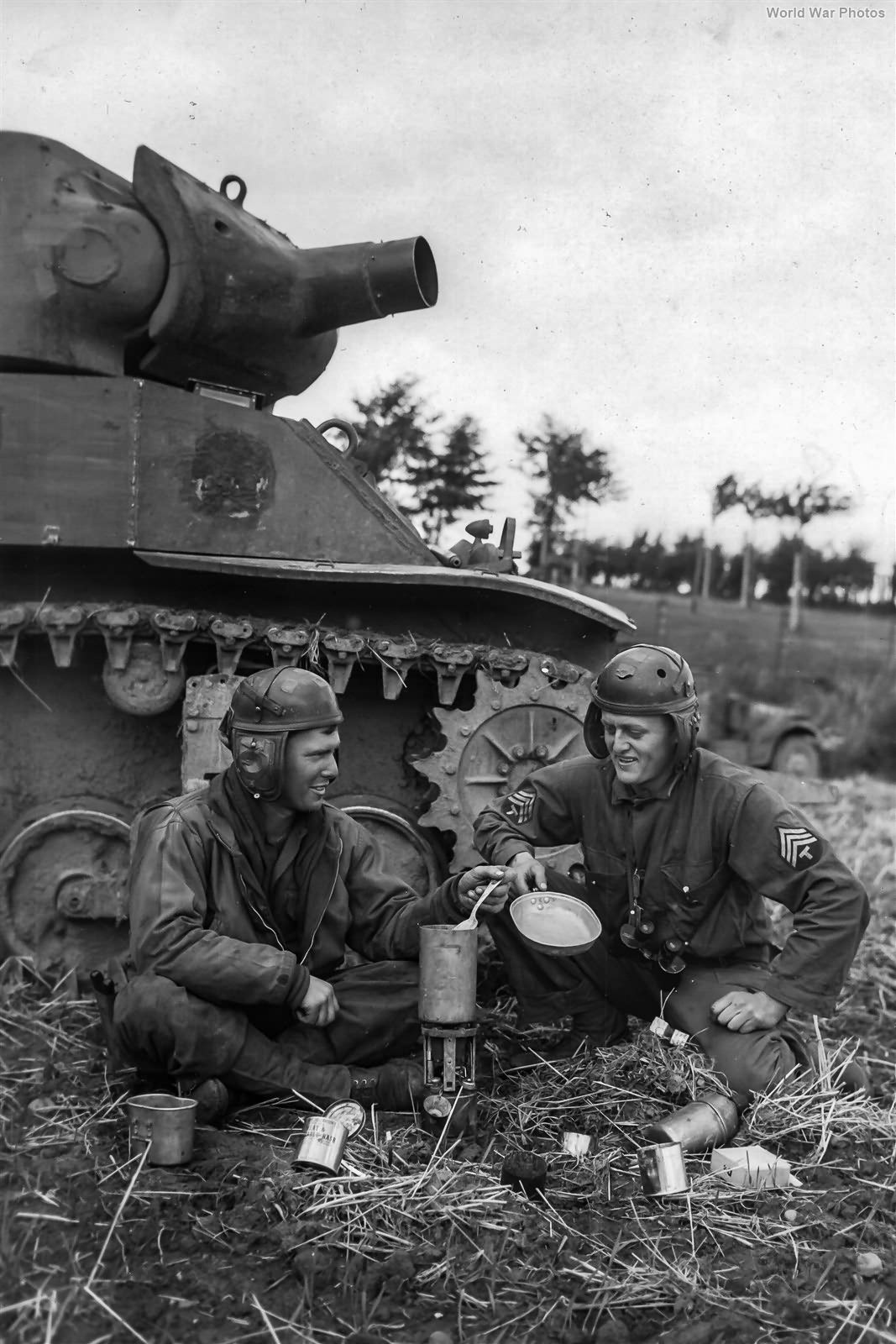 113th Cav Recon Troopers brew chow next to M8 Holland 9 September 1944