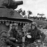 113th Cav Recon Troopers brew chow next to M8 Holland 9 September 1944