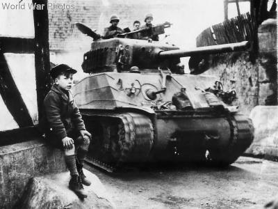 9th AD Sherman passing small German boy 1945