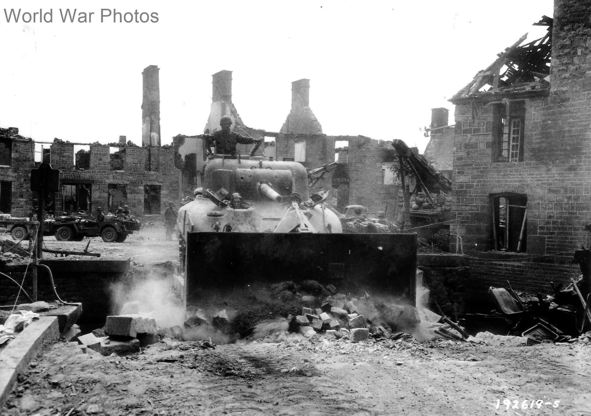M4A1 bulldozer of 66th Regiment clears the central bridge in Lonlay-l’Abbaye August 1944